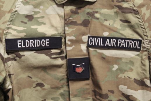 a Civil Air Patrol top with insignia and name tape